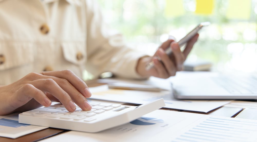 an image of a man at a desk taking a means test to determine which type of personal bankruptcy is best for him