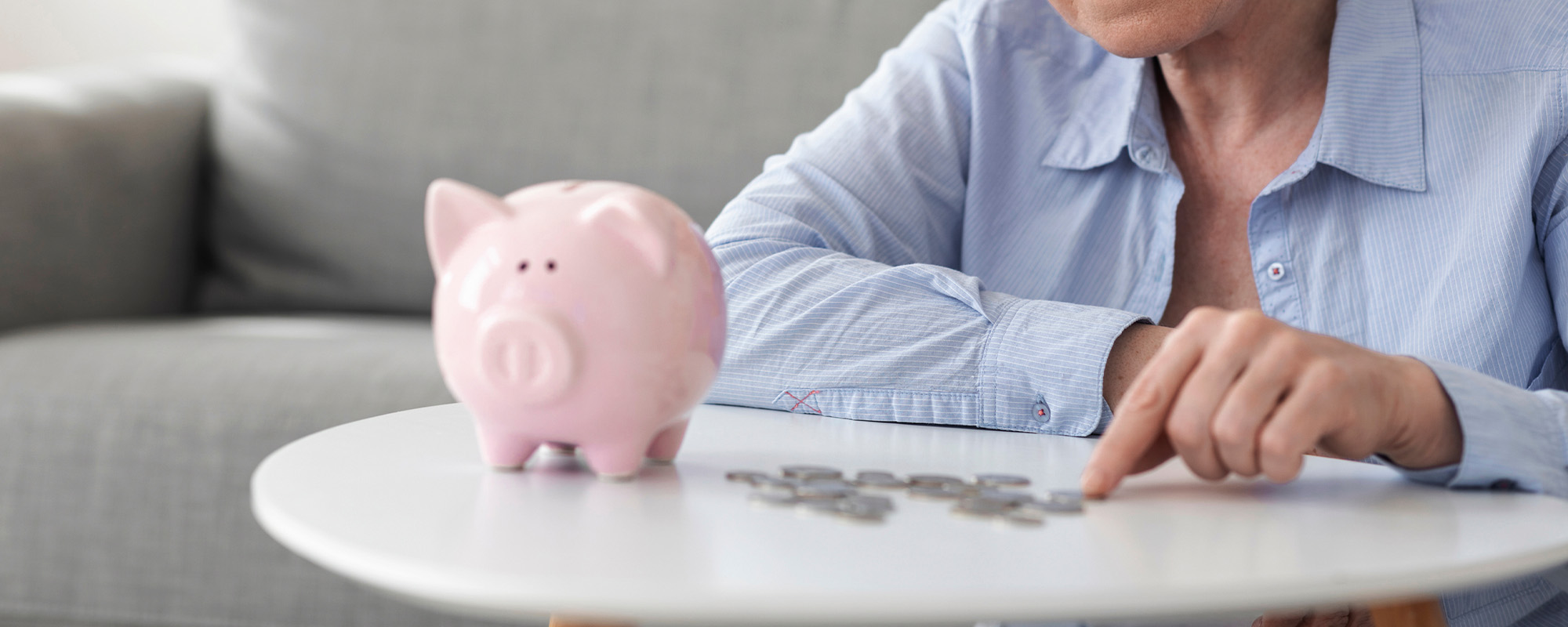 no retirement savings. upset elderly woman counting coins from piggy bank