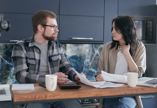 couple sitting at tale talking about finances