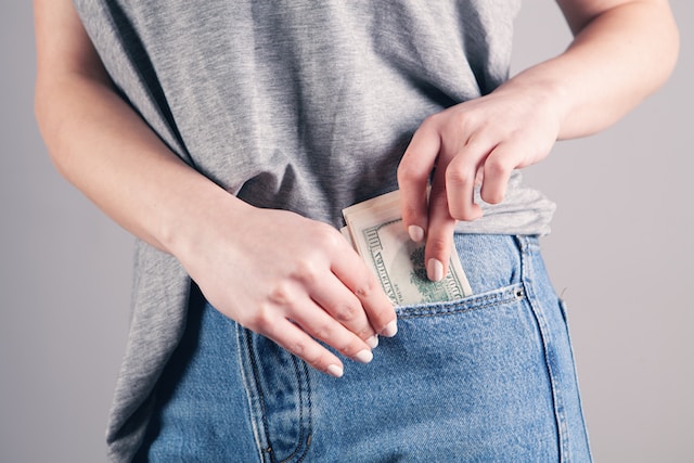 woman putting money in pocket