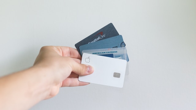 person holding credit cards