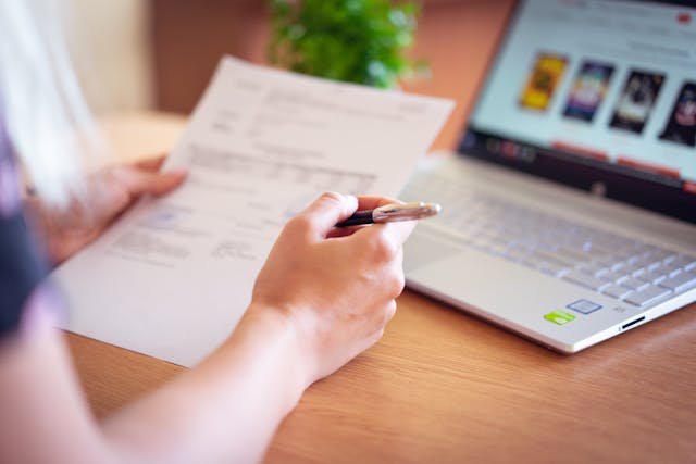 woman at computer looking at documents