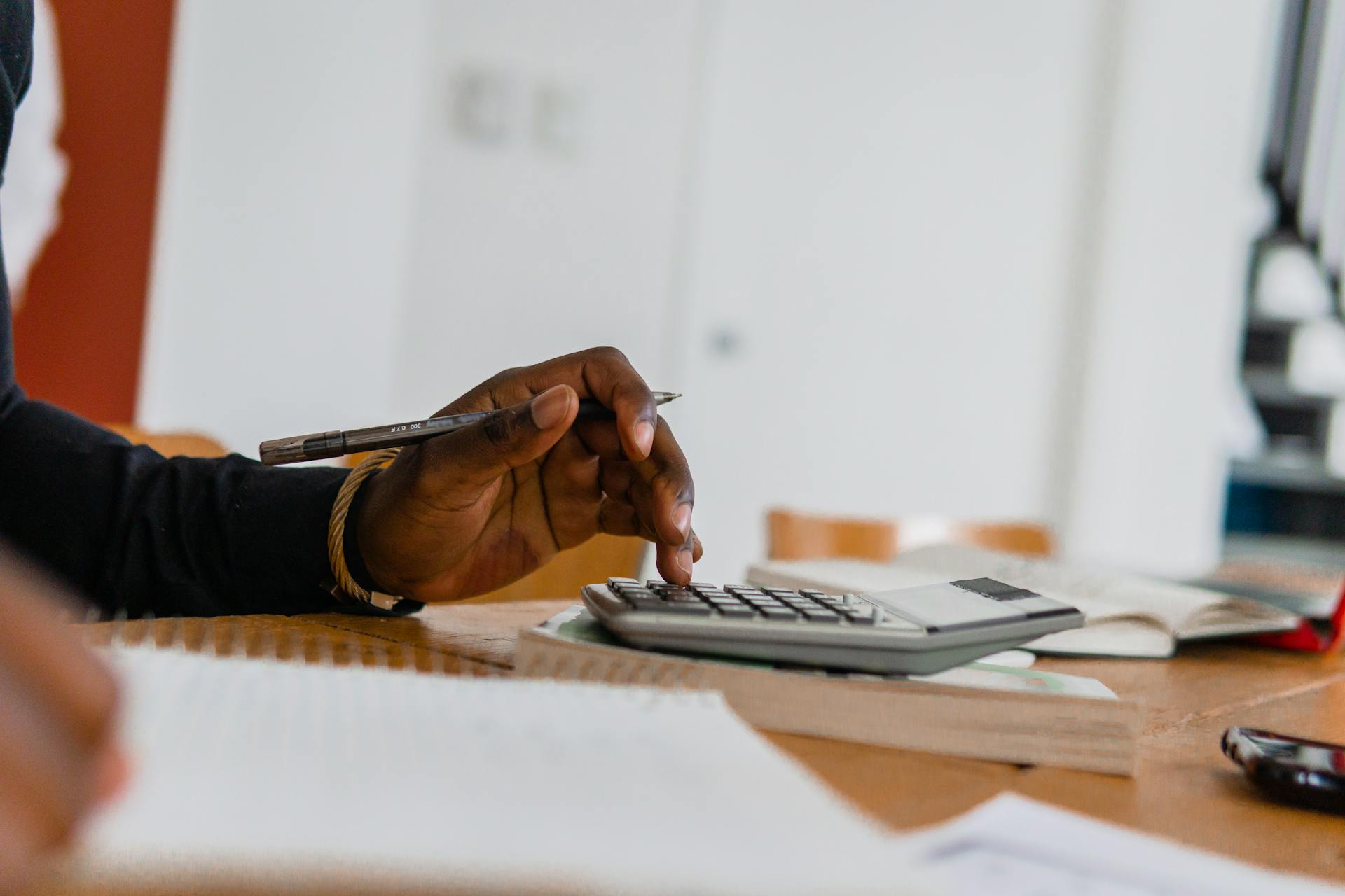 man doing calculations at desk